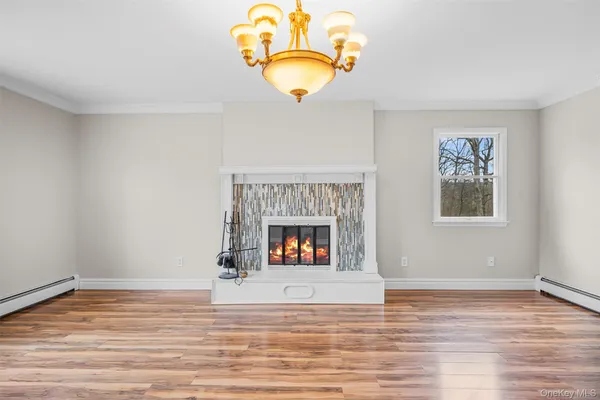 a view of a room with wooden floor and a fireplace