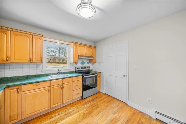 a large kitchen with stainless steel appliances granite countertop a sink and a granite counter tops