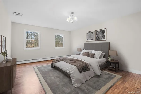 a spacious bedroom with a bed and a couch