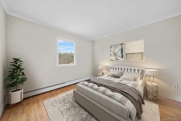 a bedroom with a bed and a potted plant