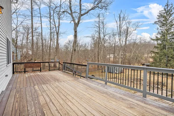 a view of balcony with wooden floor and fence