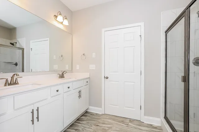 a bathroom with a double vanity sink and mirror