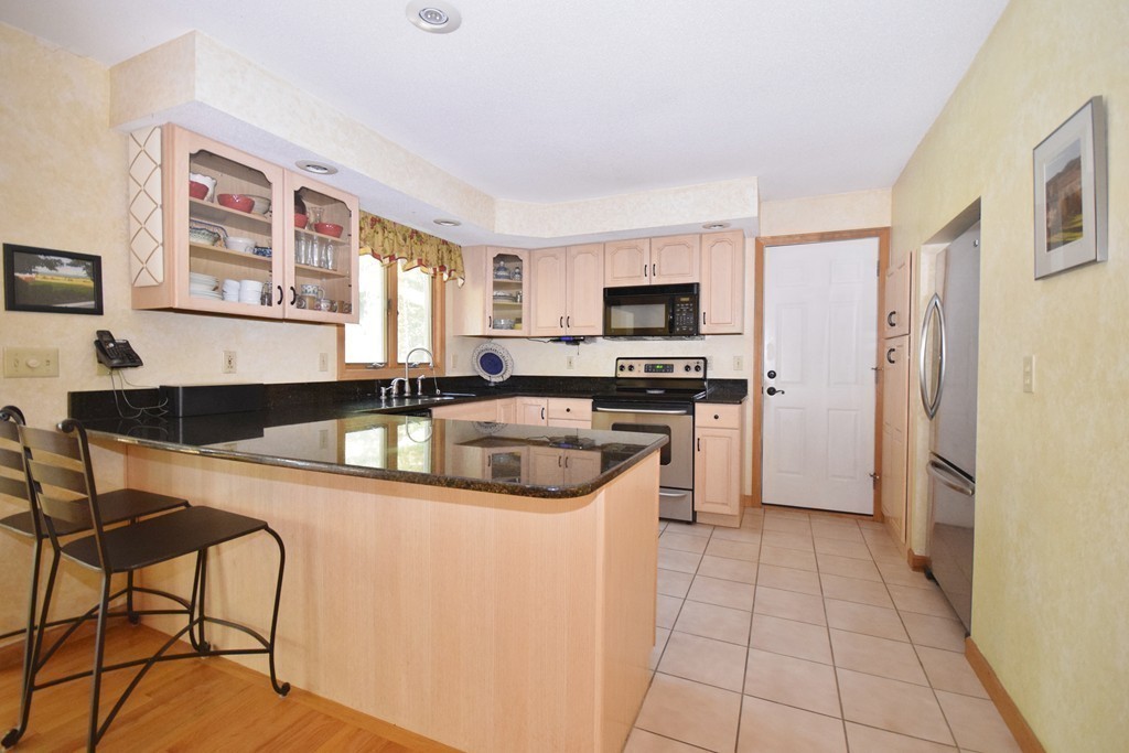 222 Somers Road Hampden, MA 01036 - Photo 11 of 30 a kitchen with a stove a sink and a refrigerator