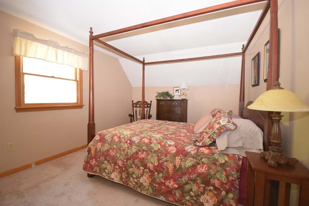 222 Somers Road Hampden, MA 01036 - Photo 9 of 30 a bedroom with a bed and a chandelier