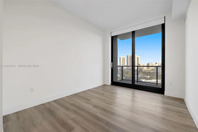a living room with furniture and a floor to ceiling window
