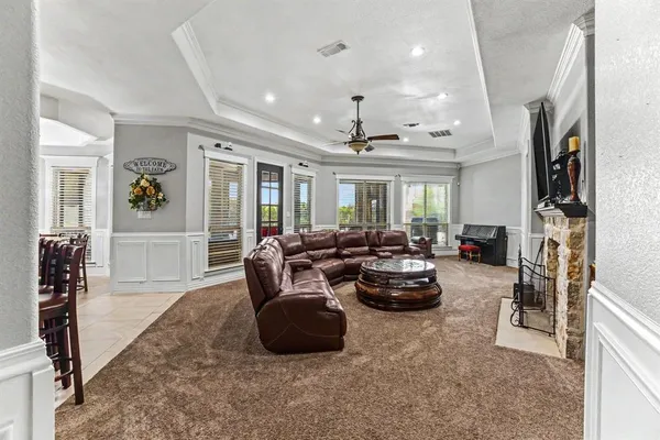 a living room with furniture fireplace and a window