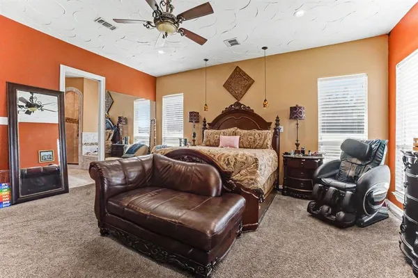 a bedroom with furniture and a large window