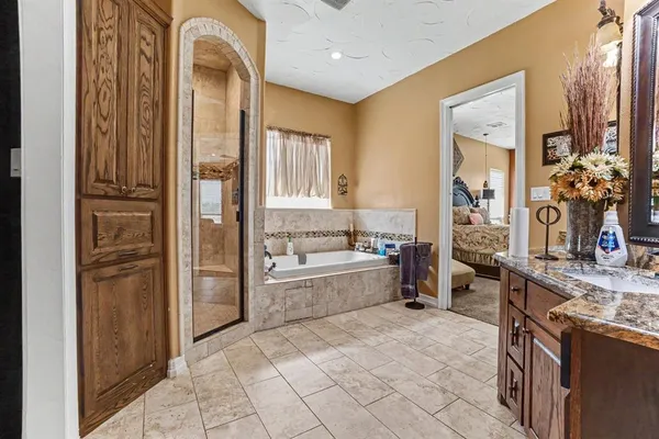 a large bathroom with a tub and shower