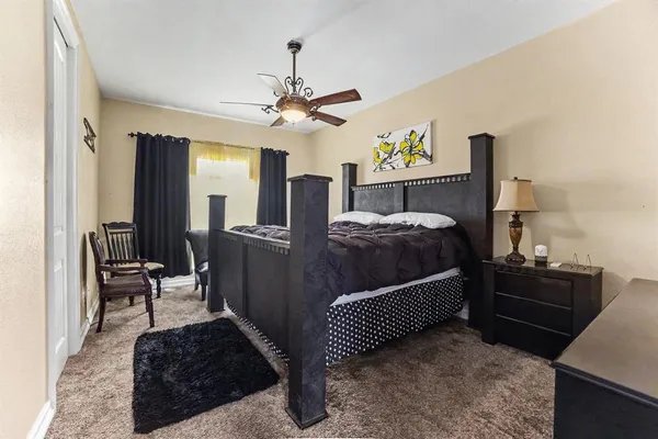 a bedroom with a bed and ceiling fan