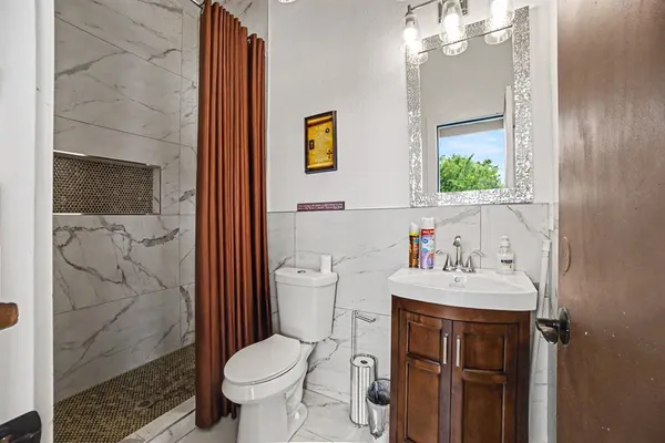 a bathroom with a sink toilet and shower
