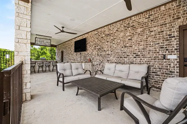 a outdoor living space with furniture and a flat screen tv
