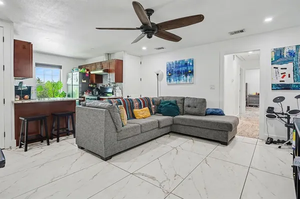a living room with furniture and a chandelier