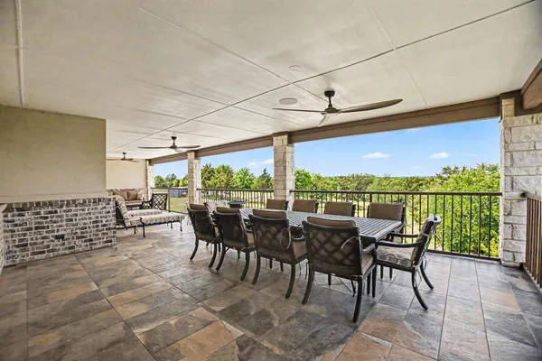 a view of a patio with chairs and floor to ceiling window