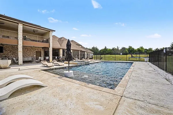a view of swimming pool with a lounge chairs