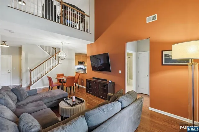 a spacious bedroom with a bed and a flat screen television