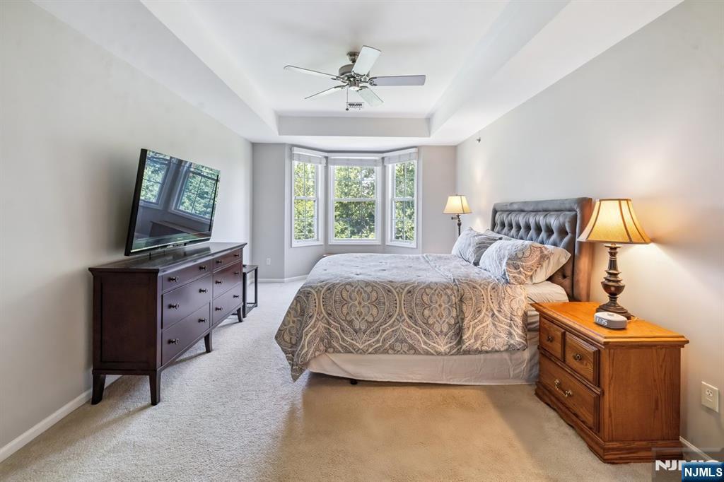 175 Rochelle Avenue, Unit 321 Rochelle Park, NJ 07662 - Photo 13 of 27 a spacious bedroom with a bed and a window