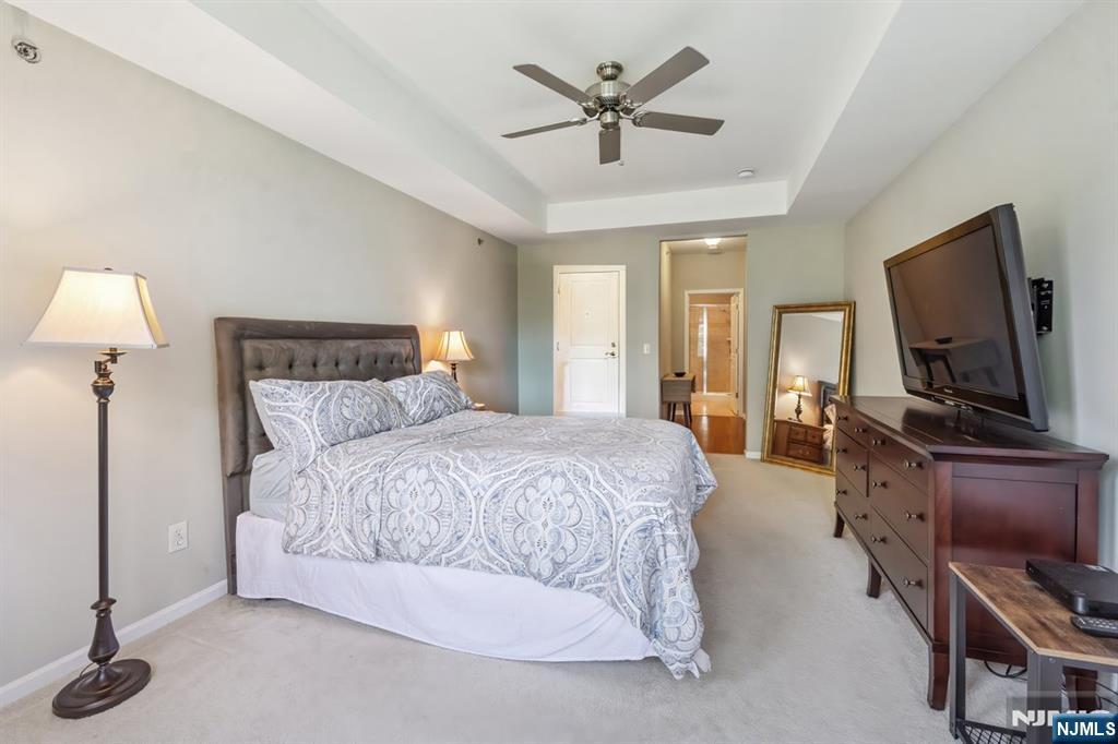 175 Rochelle Avenue, Unit 321 Rochelle Park, NJ 07662 - Photo 14 of 27 a spacious bedroom with a bed and a flat screen television