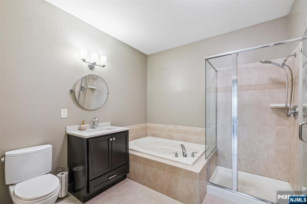 175 Rochelle Avenue, Unit 321 Rochelle Park, NJ 07662 - Photo 16 of 27 a bathroom with a sink a toilet and shower