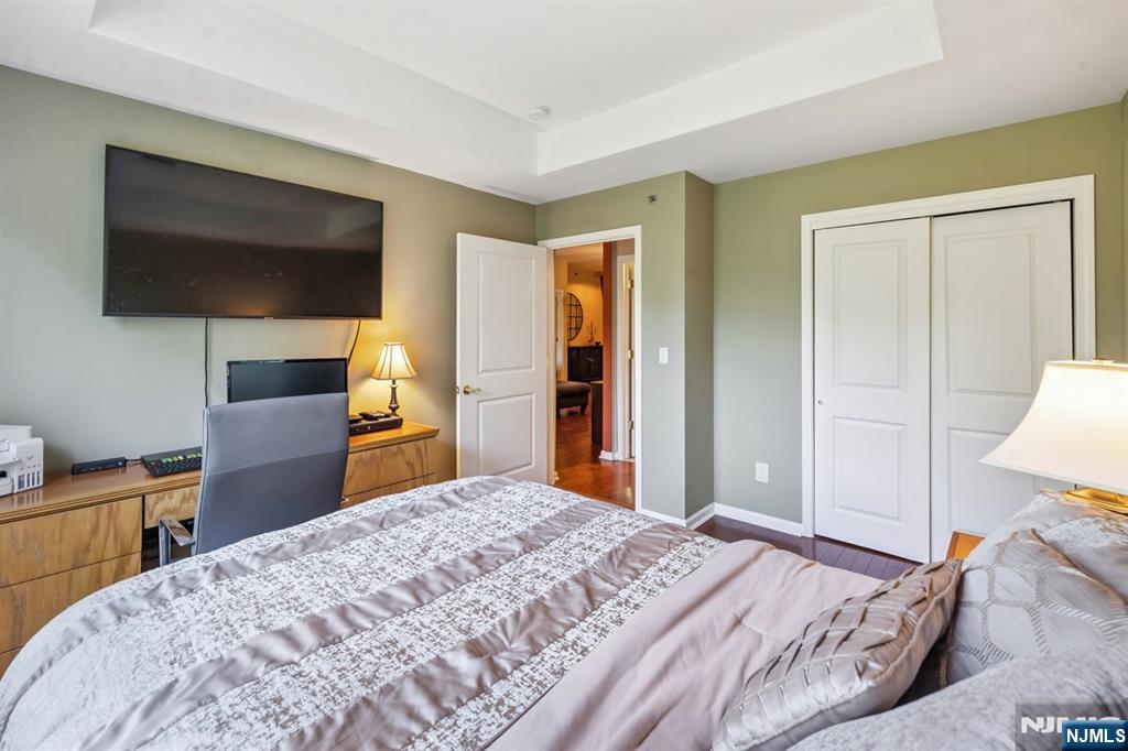 175 Rochelle Avenue, Unit 321 Rochelle Park, NJ 07662 - Photo 18 of 27 a bedroom with a bed and a flat screen tv