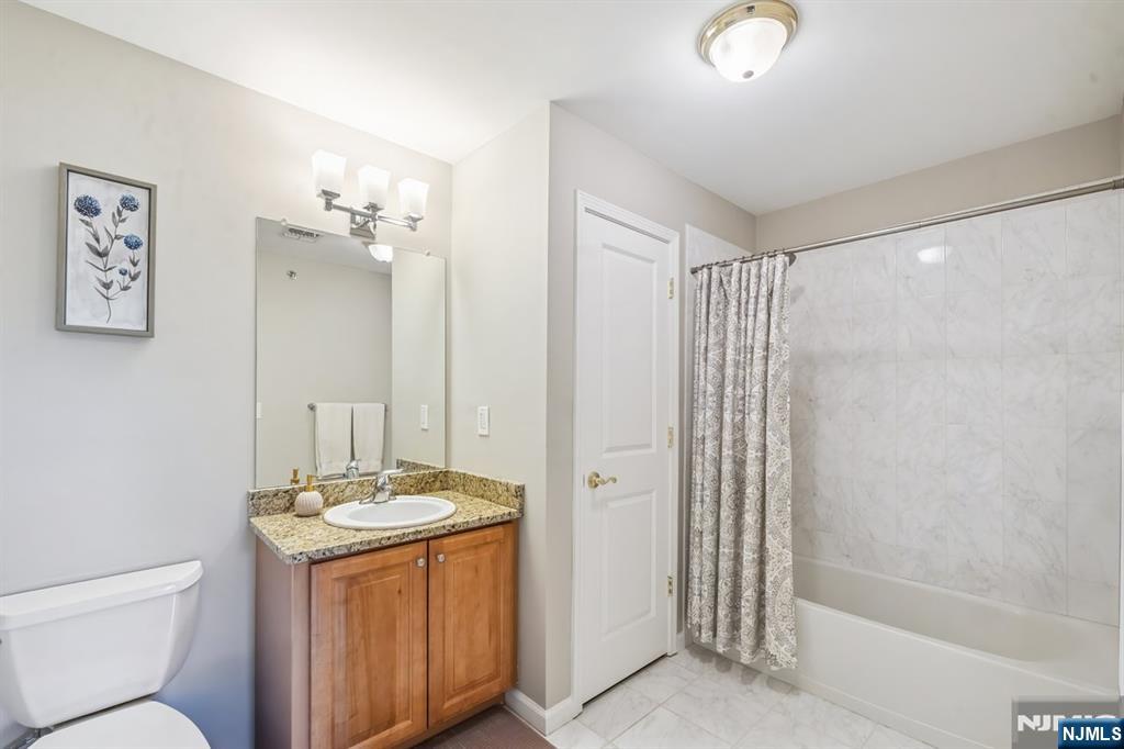 175 Rochelle Avenue, Unit 321 Rochelle Park, NJ 07662 - Photo 19 of 27 a bathroom with a granite countertop sink toilet and shower