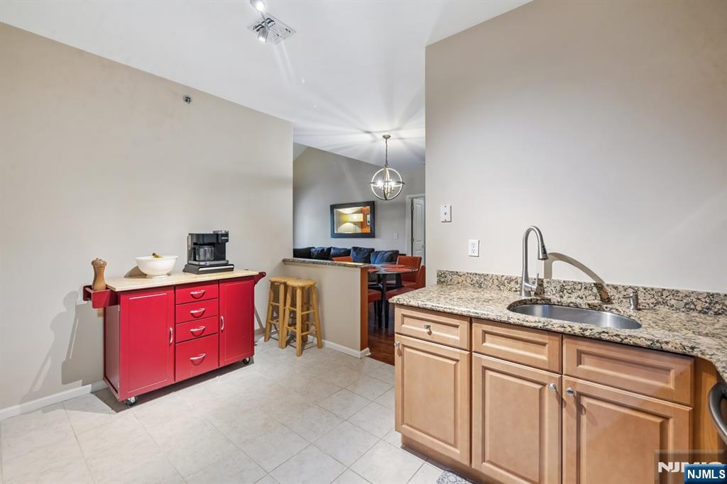 175 Rochelle Avenue, Unit 321 Rochelle Park, NJ 07662 - Photo 21 of 27 a kitchen with stainless steel appliances granite countertop a sink and cabinets