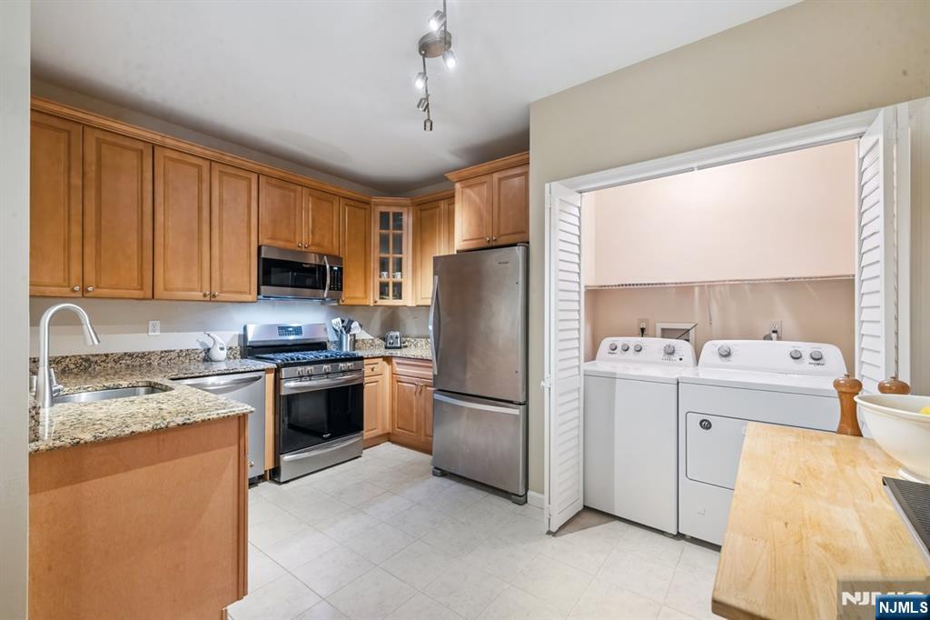175 Rochelle Avenue, Unit 321 Rochelle Park, NJ 07662 - Photo 22 of 27 a kitchen with stainless steel appliances granite countertop a refrigerator stove top oven sink and cabinets