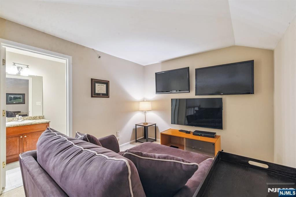 175 Rochelle Avenue, Unit 321 Rochelle Park, NJ 07662 - Photo 25 of 27 a living room with furniture and a flat screen tv