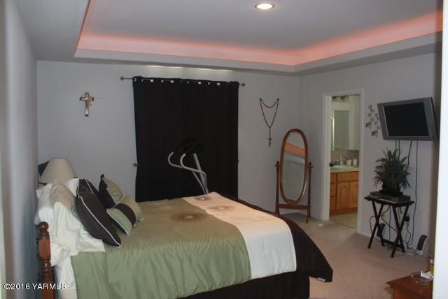 500 Blue Goose Road Zillah, WA 98953 - Photo 22 of 25 a bedroom with a bed and a flat tv screen on dresser