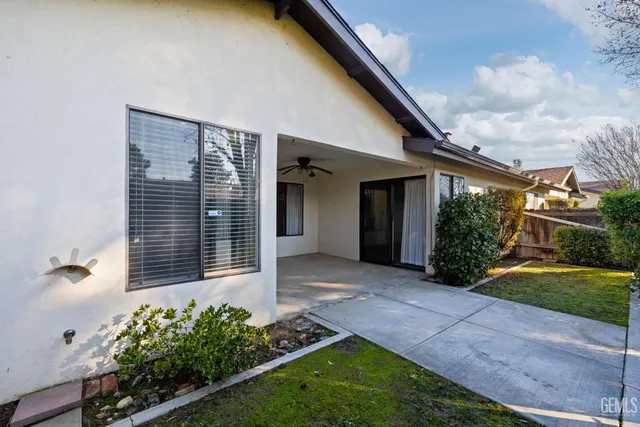 an aerial view of a house with a swimming pool and outdoor space