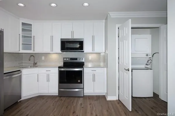a kitchen with a sink and steel appliances