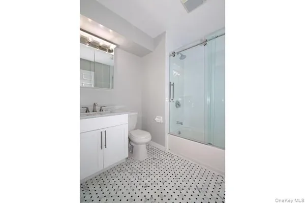 a bathroom with a sink a toilet and a shower