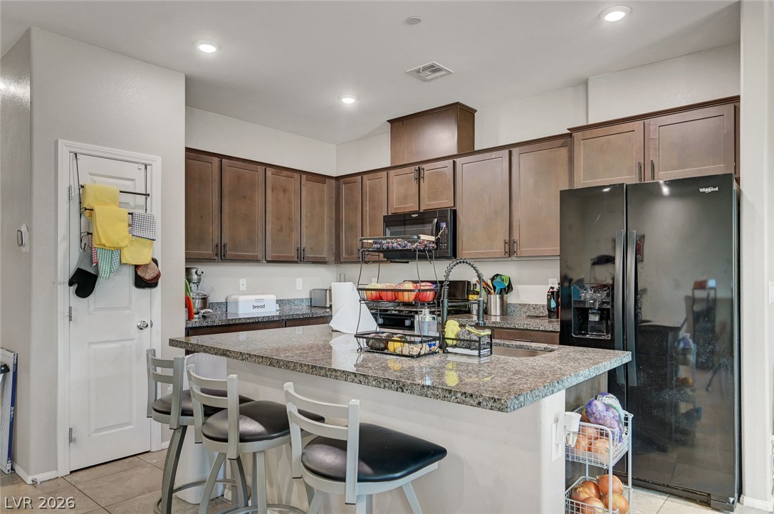 1285 Raritan Place Henderson, NV 89002 - Photo 5 of 20 Rich wood cabinetry and expansive granite countertops define this modern, functional workspace.