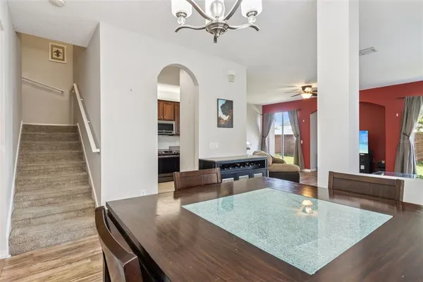 a kitchen with stainless steel appliances granite countertop a refrigerator sink and stove