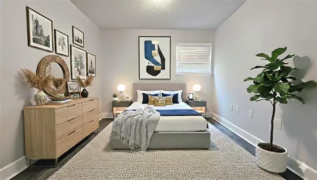 a bedroom with bed and a potted plant