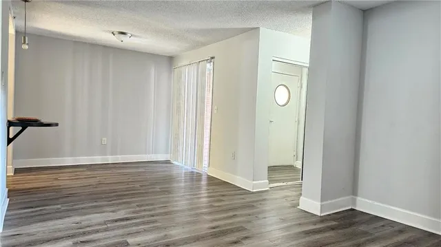 a view of an empty room and wooden floor