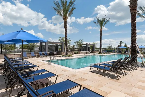 a view of a patio with swimming pool and sitting area