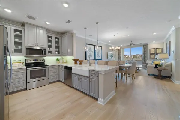 a kitchen with a sink appliances and cabinets