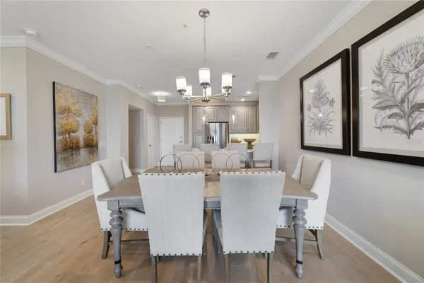 a view of a dining room with furniture wooden floor and a chandelier