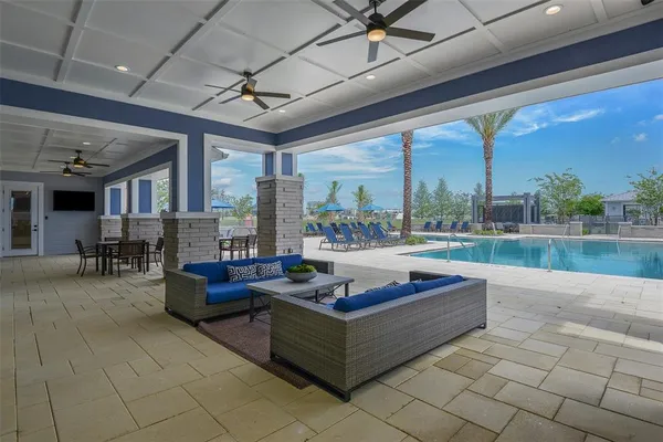 a living room with patio furniture and a garden