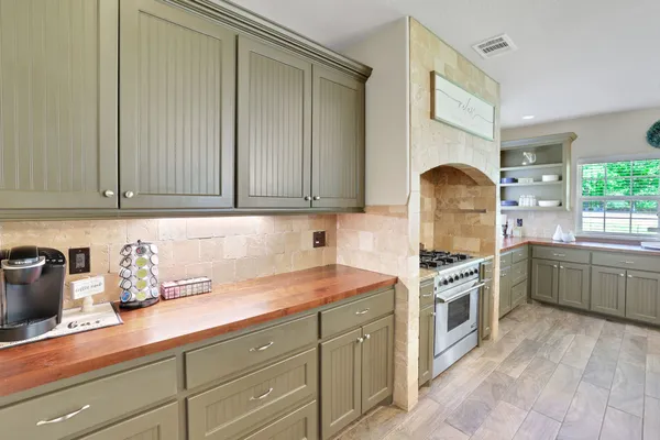 a kitchen with granite countertop a sink stainless steel appliances and cabinets