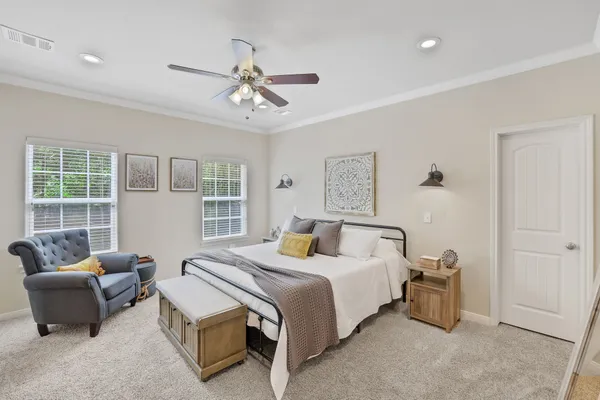 a bedroom with a bed and a couch