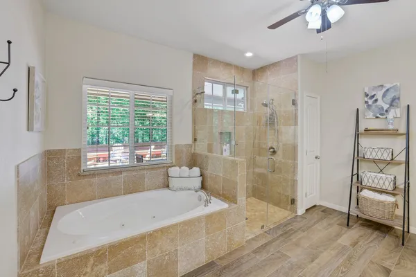 a bathroom with a tub shower and sink