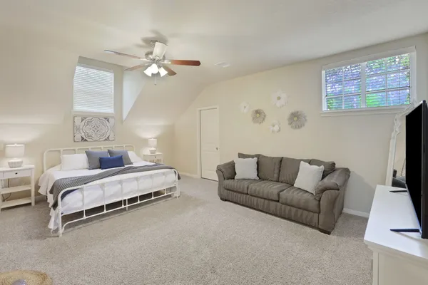 a bedroom with a bed and a flat screen tv