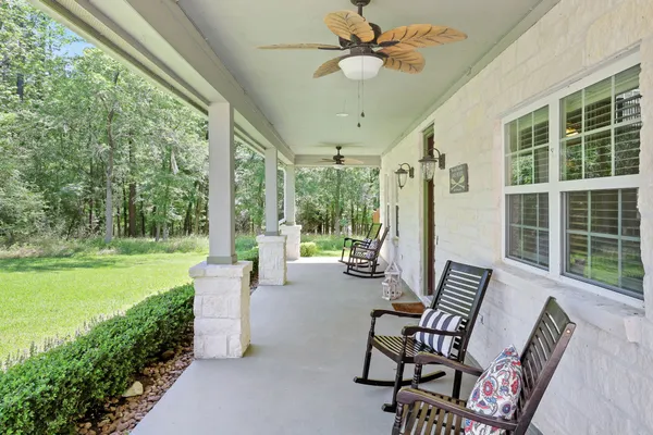 a view of a porch with furniture and garden