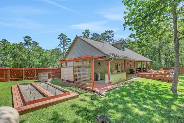 a view of a house with backyard and sitting area