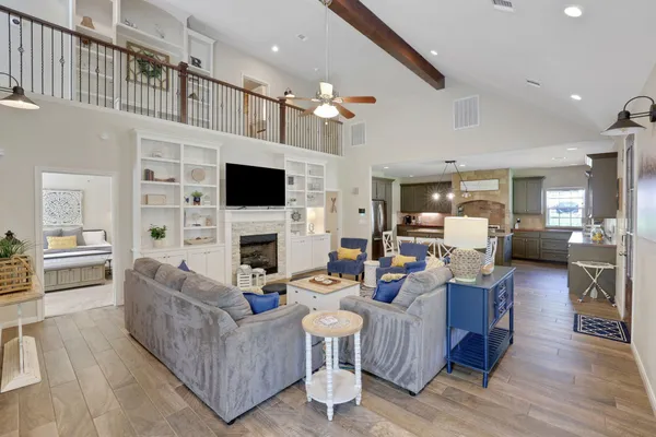 a living room with fireplace furniture and a flat screen tv