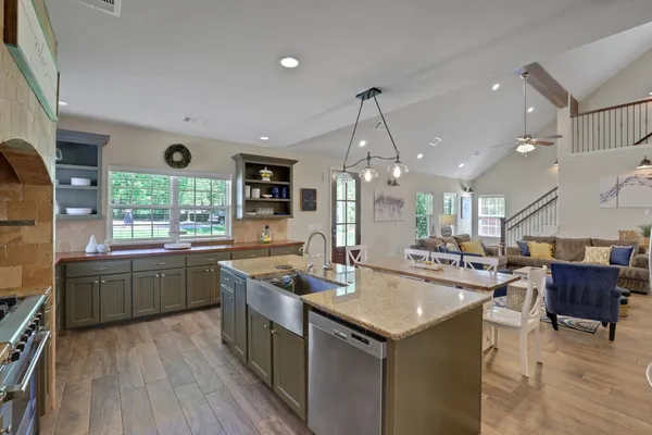 a kitchen with sink cabinets and wooden floor
