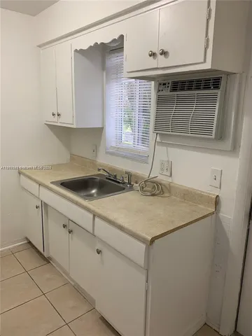 a kitchen with a sink and cabinets