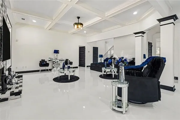 a room with furniture a chandelier and a large window