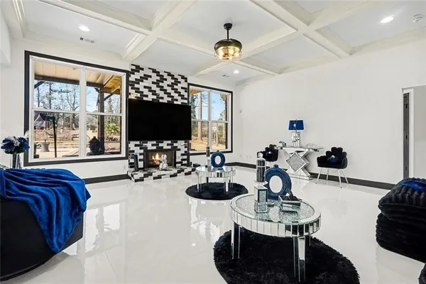 a kitchen with stainless steel appliances kitchen island granite countertop a refrigerator oven a sink a stove a dining table and chairs with wooden floor